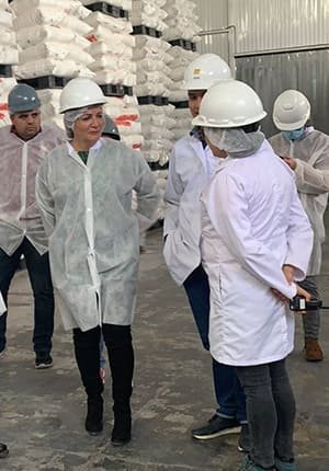 Group of people in protective clothing in our facility, demonstrating our commitment to quality and safety in plastic pallet production.