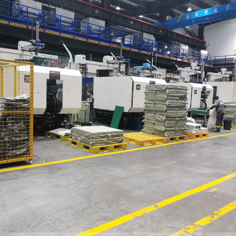 Factory with machinery. Our manufacturing, with 60+ lines, produces various plastic pallets like heavy - duty and rackable.