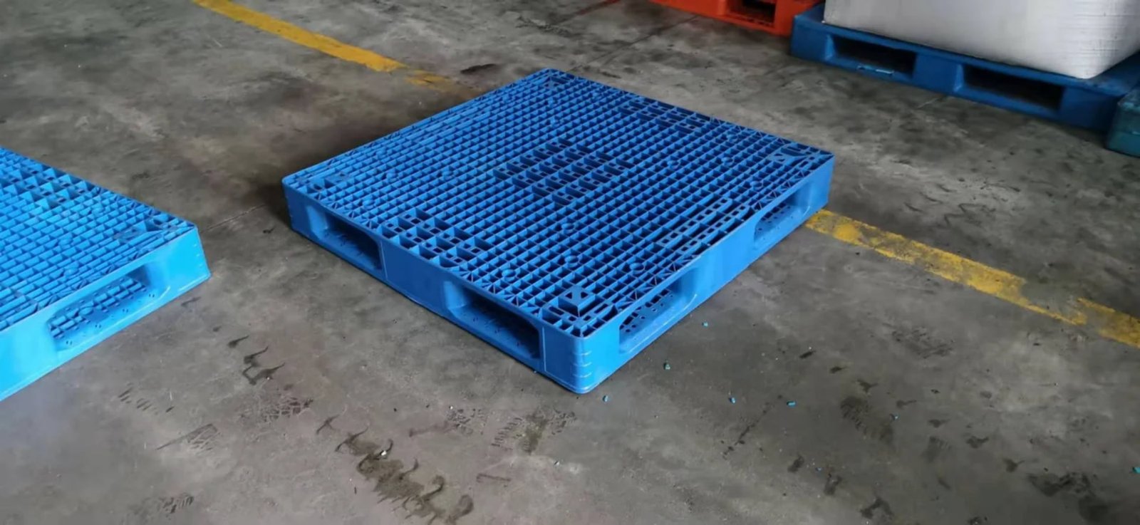 Full perimeter plastic pallets prepared for industrial handling