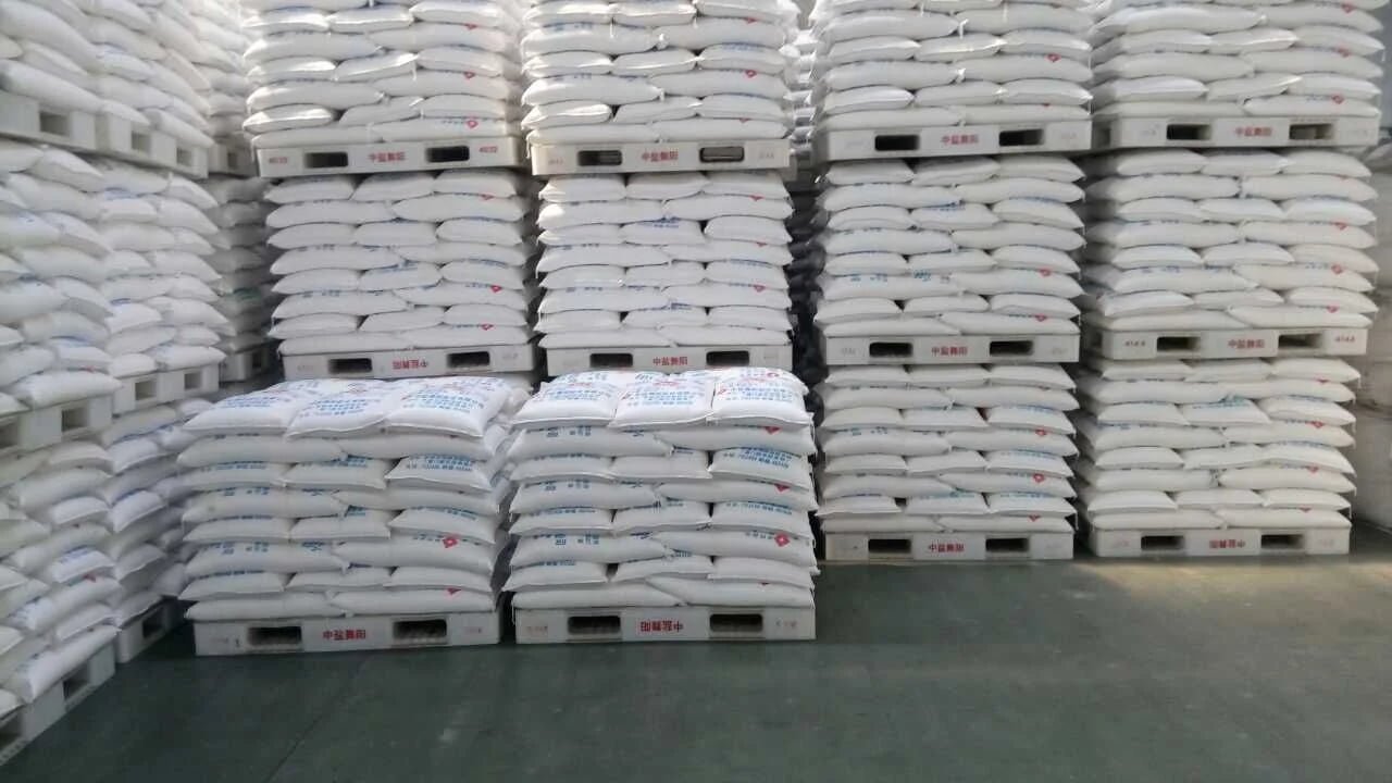 Plastic pallets supporting stacked bagged products in an industrial warehouse